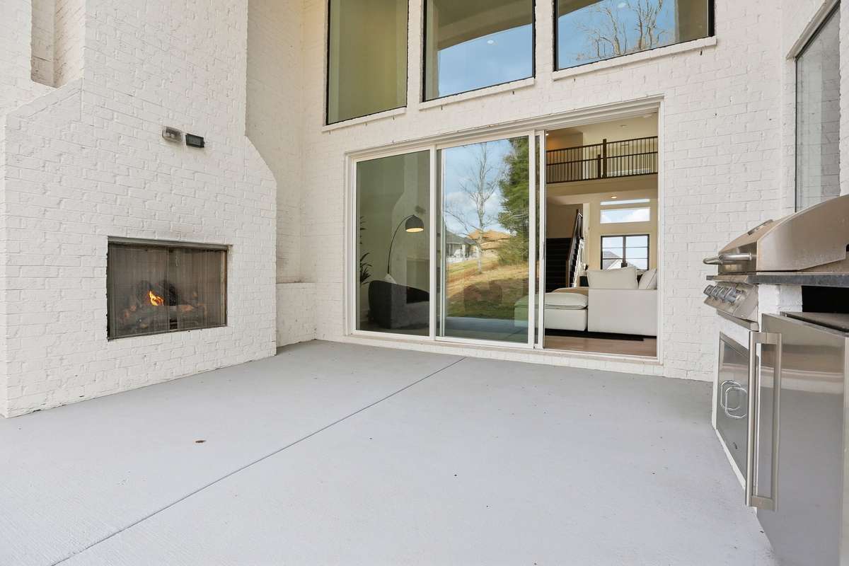 Gas fireplace in Outstanding outdoor living! Double stacked windows and sliders with 20 ft ceilings, fireplace, built in grilll