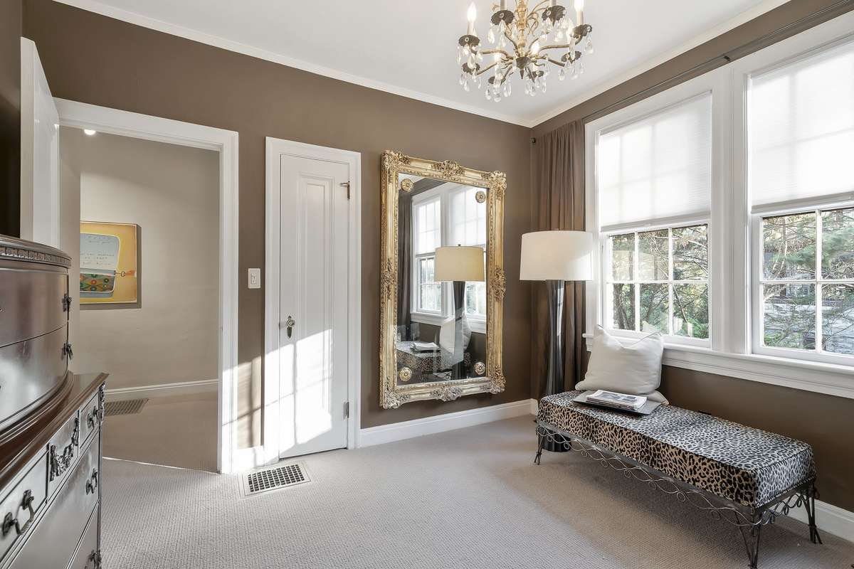 Used as a dressing room, this main-level second bedroom is conveniently located right off the main bathroom and enjoys wonderful afternoon sunlight.