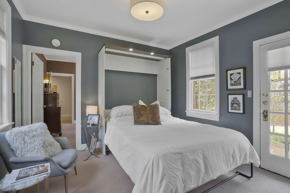 The 3rd Main Level Bedroom has a Murphy Bed that comes with the home and converts into a desk when not in use.