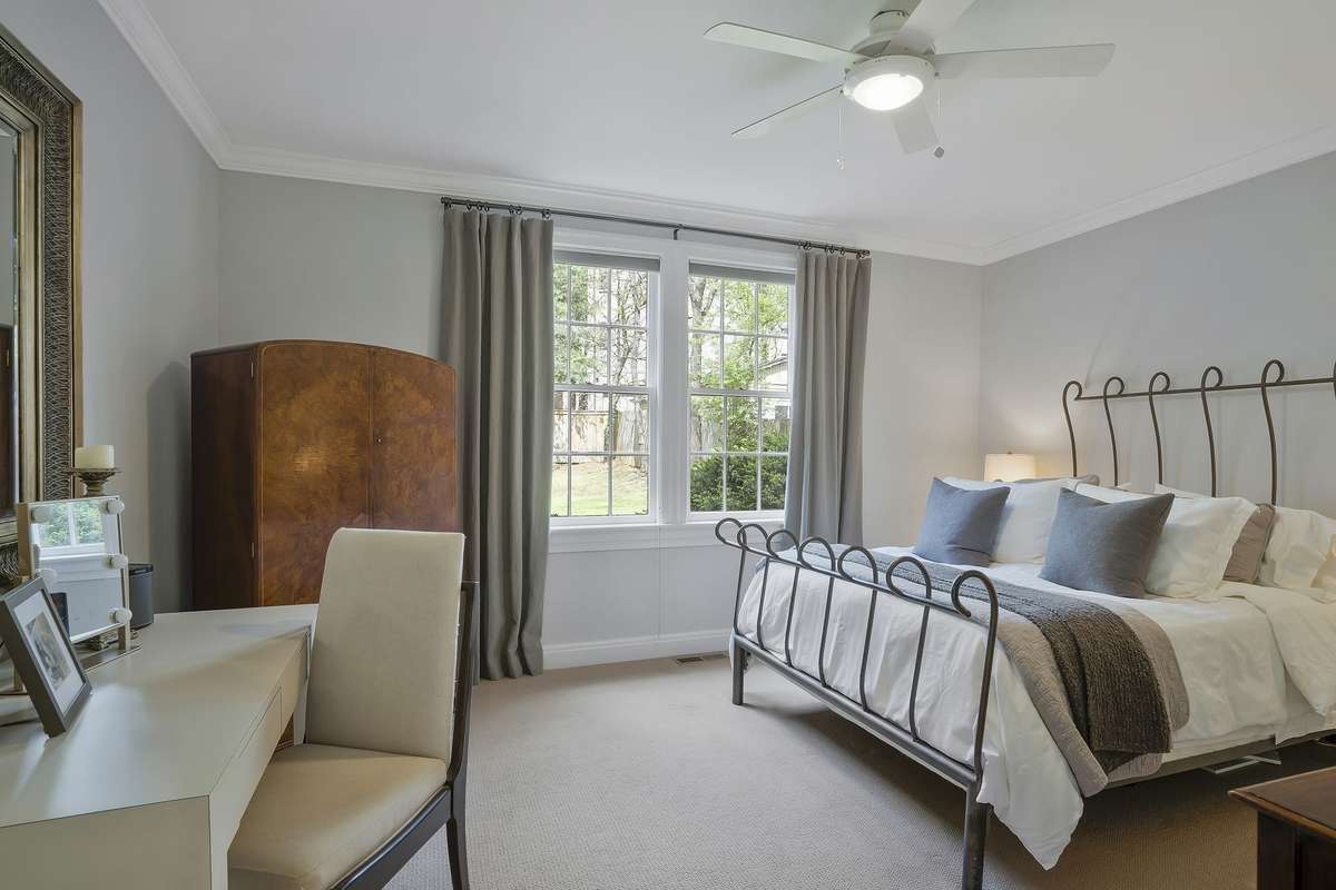 The primary main-level bedroom overlooks the spacious backyard and stone patio!
