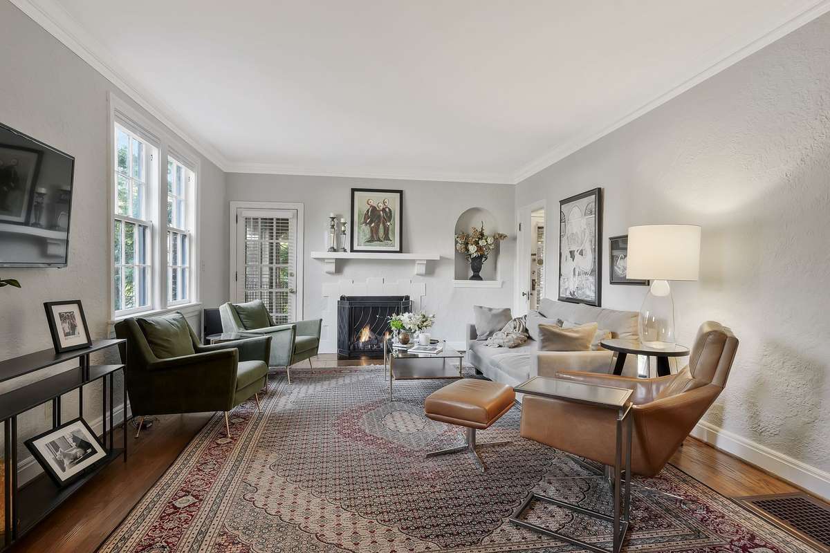 Another view of the living room with a much-loved ventless gas fireplace and entry door to the second level of the home.