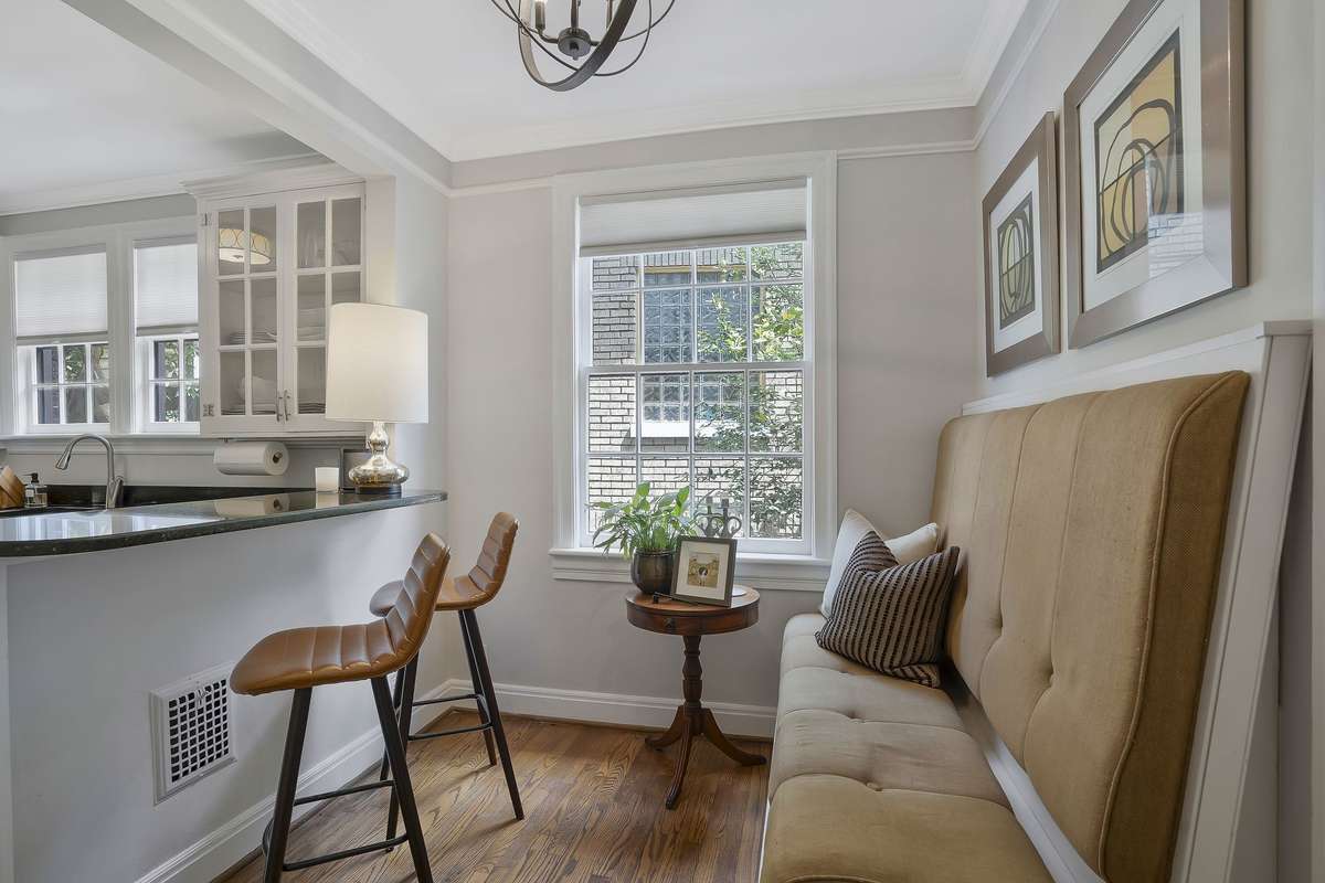 Breakfast area flows into the kitchen with a new Light fixture, and a Built-in Banquette with additional storage.