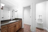 This half bath is off the basketball/pickle ball court.