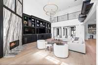 A sexy floor to ceiling custom marble fireplace is the focal point of the living space.