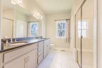 The primary ensuite has a tiled walk-in shower and two XL walk-in closets.