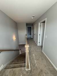 upstairs hallway leading to all three bedrooms, laundry room and secondary bathroom