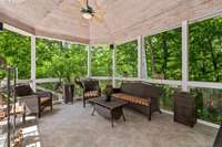 The lounge overlooks the wooded back yard which leads to the water.