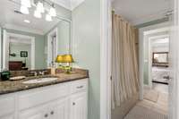 The two bedrooms share an en-suite bathroom and each bedroom has its own vanity and sink.