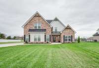 Stunning all-brick home with gorgeous curb appeal, set on a spacious .65-acre lot.