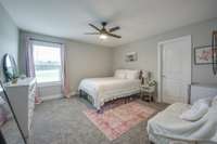 Comfortable and inviting third bedroom located upstairs with plush carpeting and ample natural light/walk-in closet.