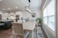 Open dining area flowing seamlessly into the kitchen and living spaces.