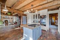 View from the kitchen looking through the dining area to the living room. The primary bedroom is through the door to the right.