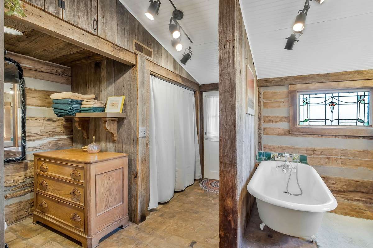 Full-size washer and dryer are located behind the screen, and convey with the property. The door leads onto the back patio.