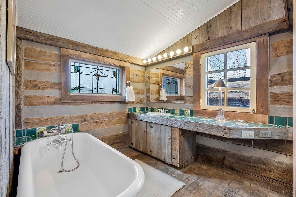 The primary bath has an antique clawfoot tub and separate shower.