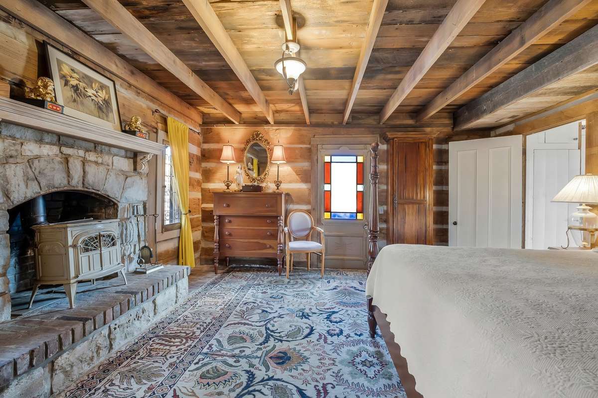 Another view of the primary bedroom. The floor under the rug is reclaimed brick.