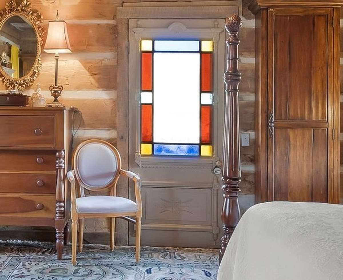 This vintage stained glass Bishop's door leads out to the right side of the home.