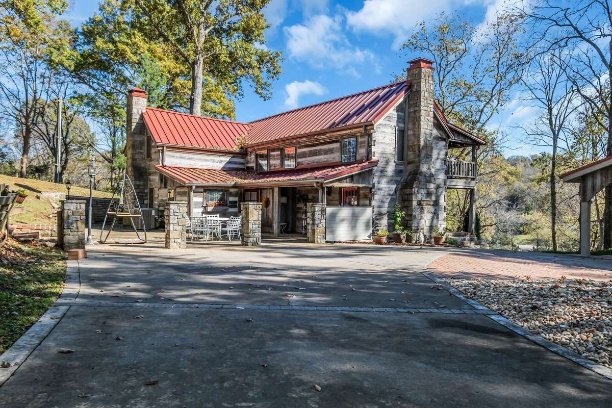As you enter the circular driveway, you're greeted by equisite stonework done by Braxton Dixon. The current owner has added a 2-car carport constructed of reclaimed timber.