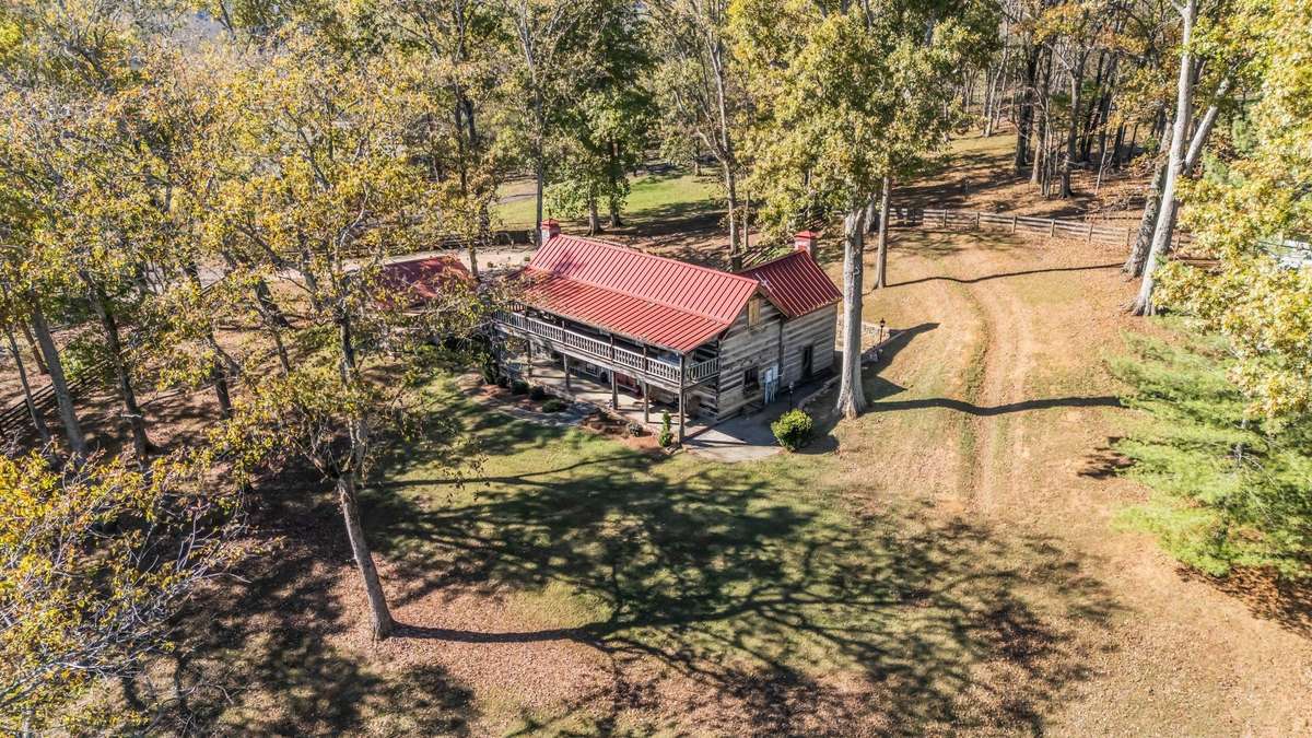 After purchase, the owner hired an engineer to design an improved drainage plan for the hill behind the home. The plan was completed, and you can see the drainage swale in this photo that directs any water runoff well to the right side of the home.