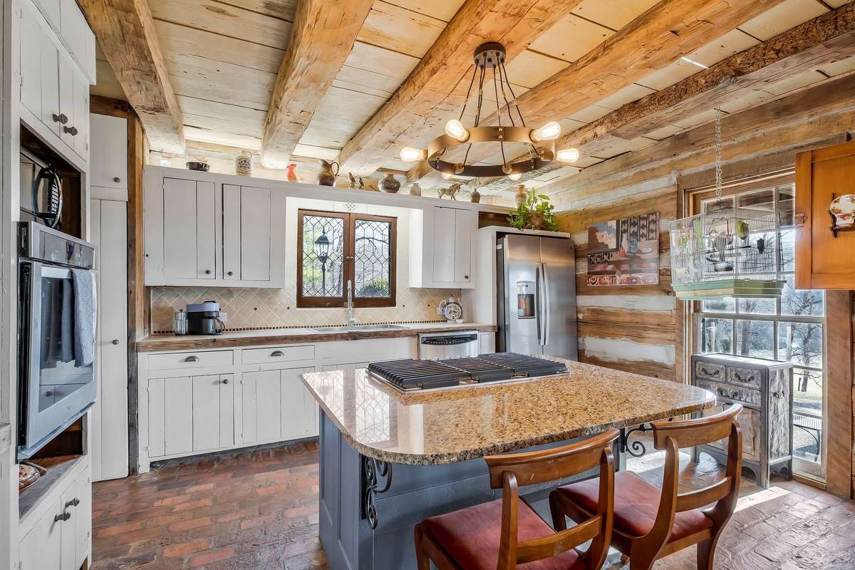 A propane cooktop is located in the kitchen island. The oven is electric.