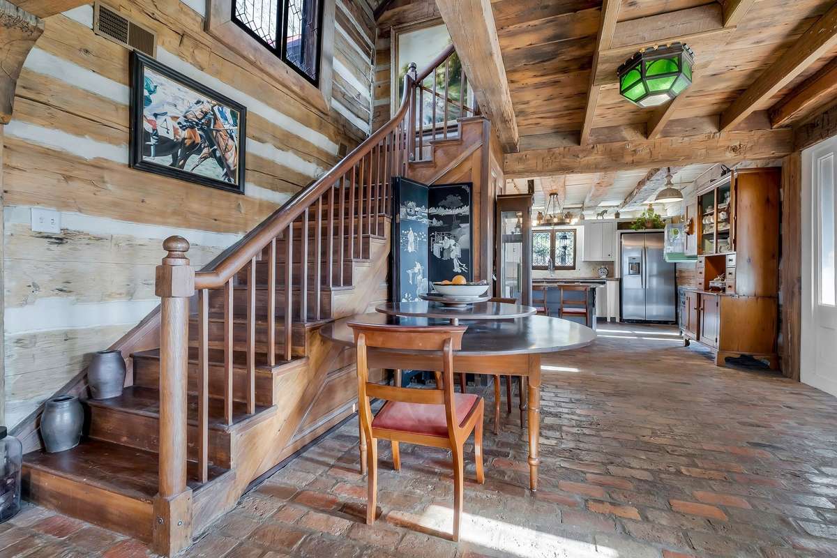 The staircase is simple, yet beautiful. Vintage leaded glass windows light the stairwell.