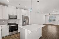This roomy kitchen island and built in desk/cabinet storage makes this open floor plan the center of this home
