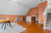 Spacious bonus room with soaring ceilings above the garage, stunning hardwood floors, and plenty of space—perfect for entertaining, a game room, or a cozy movie night!