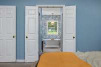 Spacious main-floor primary bedroom with a professionally updated, spa-like bathroom featuring a soaking tub, walk-in shower, double vanities, and large walk-in closets—your personal retreat awaits!