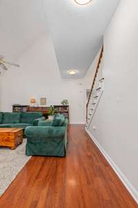 Spacious living room with a cozy fireplace and serene views of the backyard—ideal for both everyday living and entertaining guests!