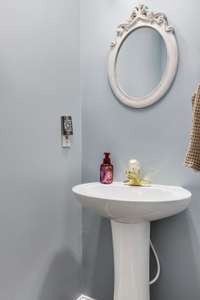 Convenient half bathroom on the main floor—perfect for guests, with stylish finishes and easy access from the main living areas.