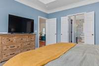 Spacious main-floor primary bedroom with a professionally updated, spa-like bathroom featuring a soaking tub, walk-in shower, double vanities, and large walk-in closets—your personal retreat awaits!