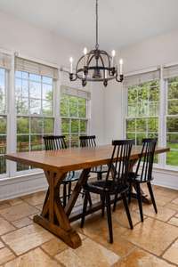 Enjoy views of the backyard oasis from this spacious kitchen, complete with a granite island, an abundance of cabinetry, upgraded backsplash, and a cozy eat-in breakfast area. Just steps away from the outdoors—perfect for everyday living!