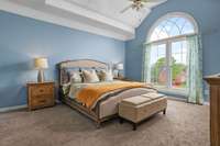 Spacious main-floor primary bedroom with a professionally updated, spa-like bathroom featuring a soaking tub, walk-in shower, double vanities, and large walk-in closets—your personal retreat awaits!