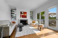 Open, large living room where the sun shines in. Built-in cabntery and shelving. Access to a wonderful outdoor deck.