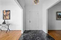 Welcoming entrance way leads to hardwood floors throughout