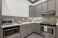 Basement-level living includes spacious full-sized kitchen.
