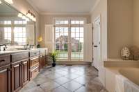Spacious master bath with oversize linen closet, 72"x42" marble tub, and spacious shower