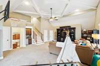 Bonus Room with coffered ceiling, wet bar, dual stairways, dedicated half bath, linen closet, and separate walk-in closet