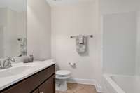 Bathroom #2 with traditional tub/shower combo.