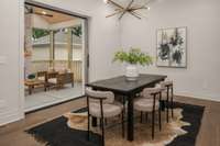Light filled dining room with sliding doors leading outside to the screened porch.