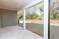 Incredible Covered Back-Porch with a Tree-Lined backdrop.