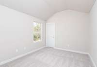 Bedroom #2 with a Walk-In Closet and Vaulted Ceilings