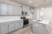Stone-Grey Cabinets with Quartz Countertops overlooking the Formal Dining Room