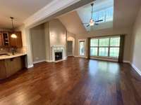 Open floor plan on the main level - beautiful engineered hardwood flooring, calm neutral paint color and high ceilings in the living room.  Lots of natural light here!