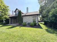 Back view of the home - enjoy the shaded back patio and open patio is great for your grill or flowers!