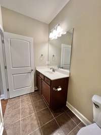 Roomy bathroom with nice tile flooring.