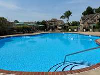 Wonderful pool area with several lounge chairs and also a separate area with tables and a tv to enjoy!