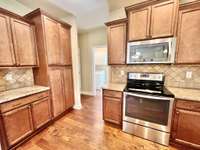 Roomy kitchen with hardwood flooring