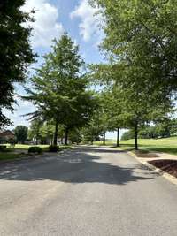 Tree lined entrance into this quaint little neighborhood is so nice - tucked away in Five Oaks!