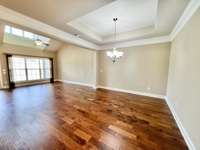 The living room and dining room are open to one another.  Crown moulding and a volume ceiling in the dining room - plenty of space for your special dining furniture.