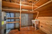 Lower Level Storage Room with Heavy Duty Shelving and Work Sink make cleaning up easy. Store life jackets, wakeboards, or hunting equipment on the large shelves.